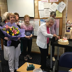 Photo of Heather Roseby cutting her birthday cake