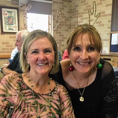 Photo of Jeanette and Lori with antlers