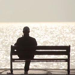 Photo of man alone on bench